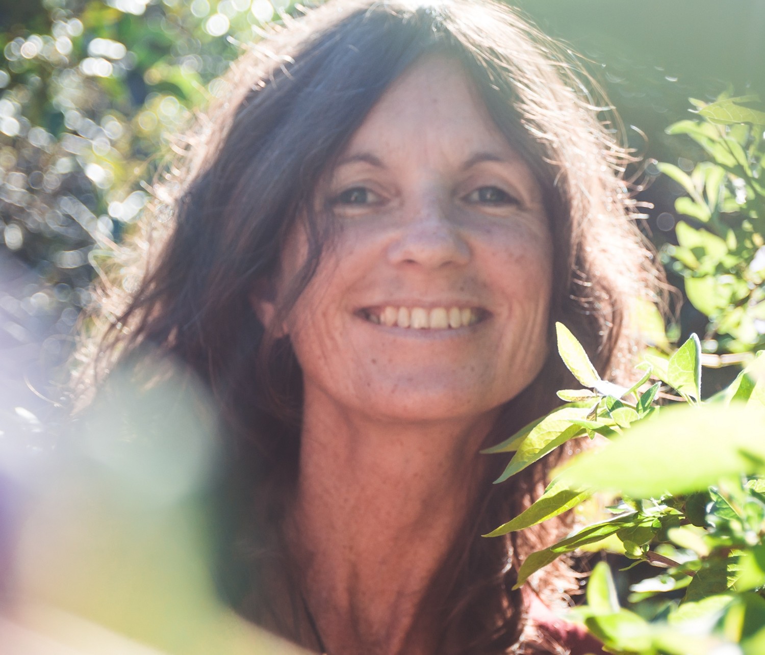 Caroline Moore smiling outdoors in a garden